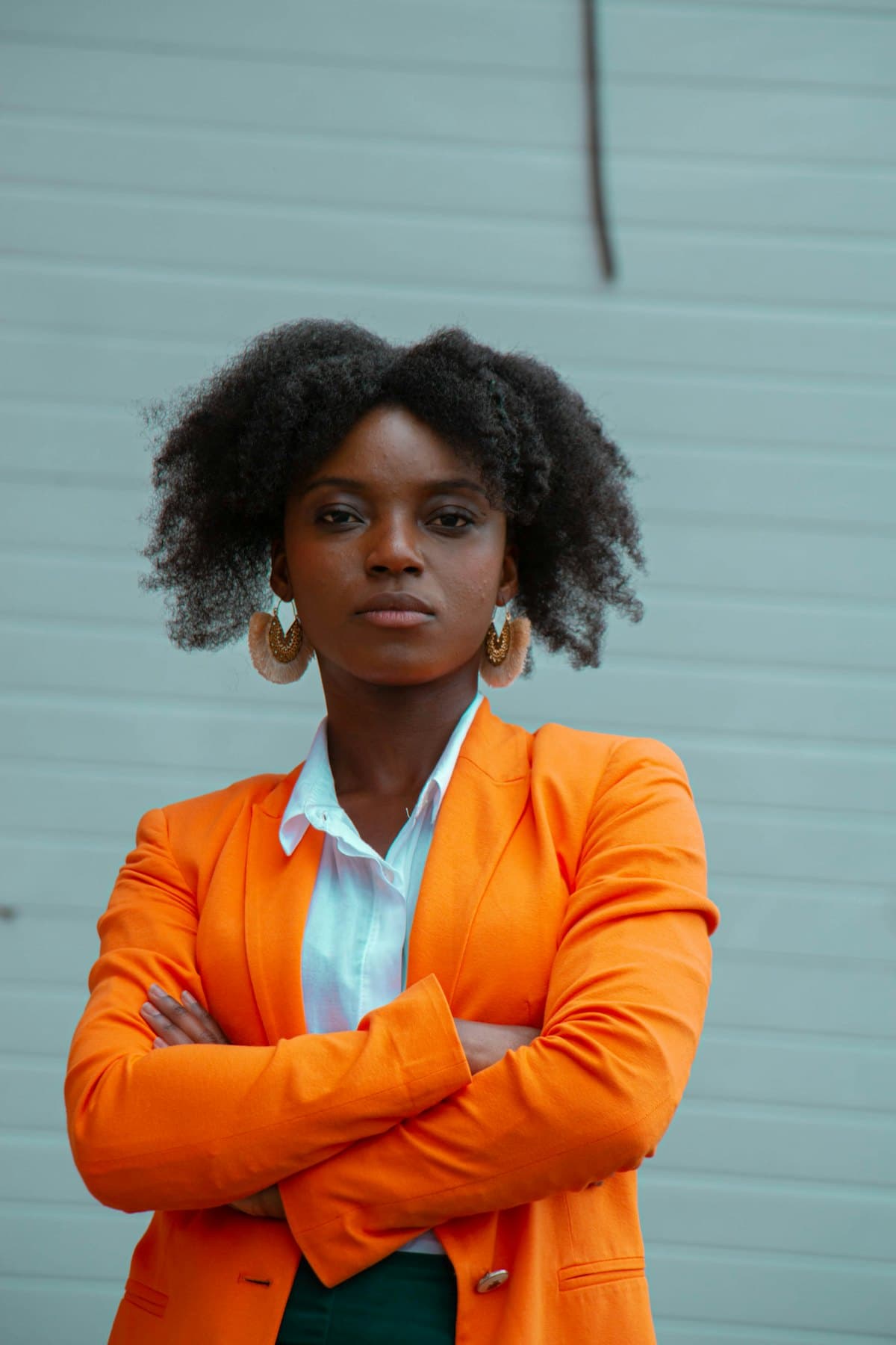 A business owner standing with her arms folded